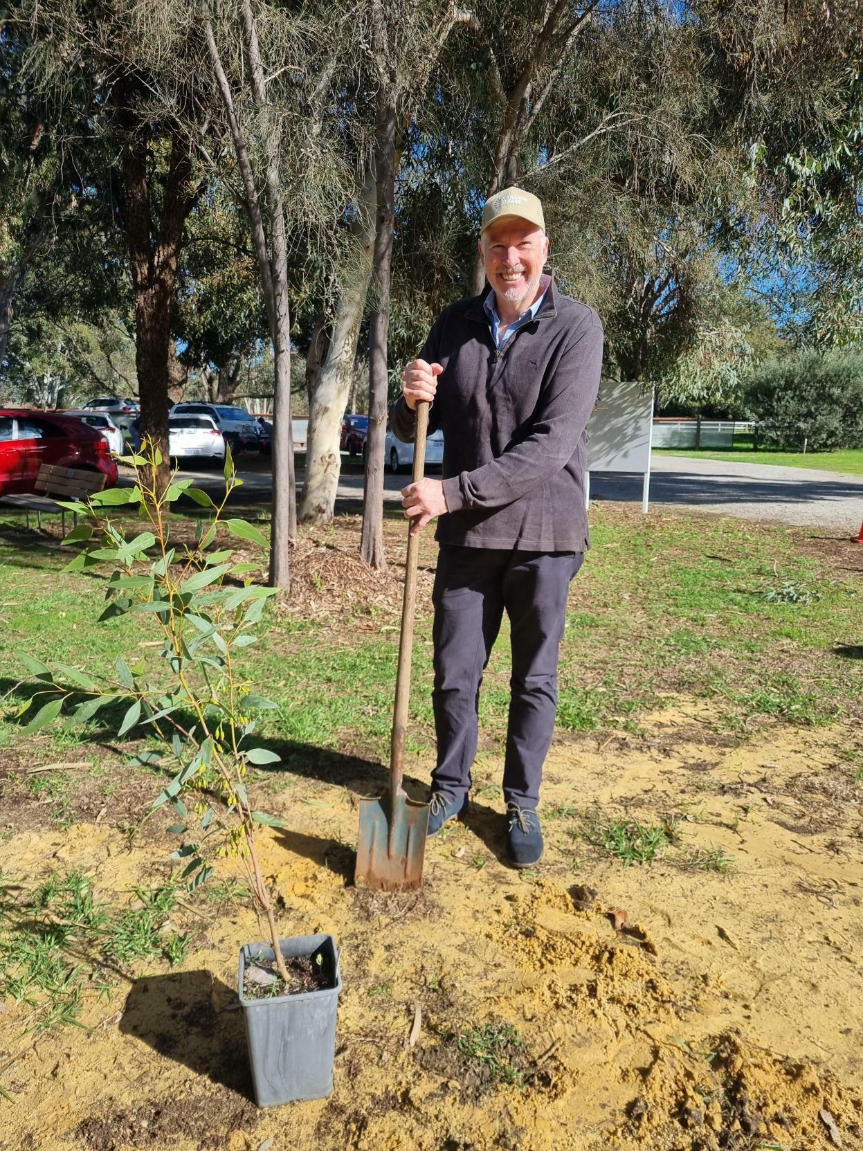 Mark Hullett planting a tree